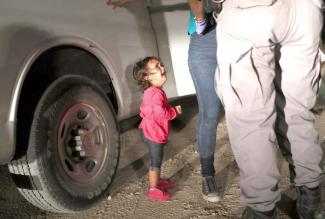 Honduran two-years-old girl sobbing at the U s border as police search her mother